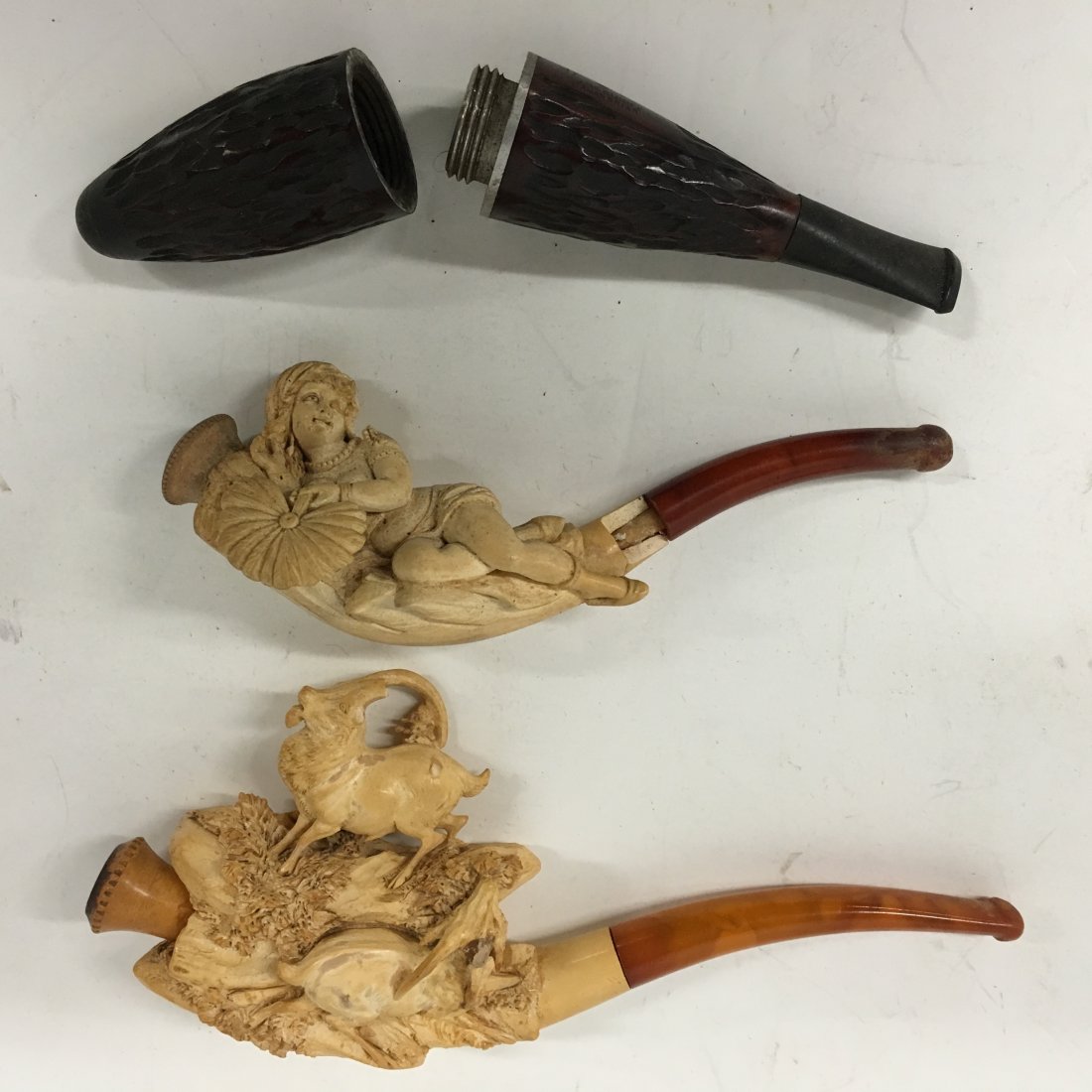 Meerschaum Pipes and Tobacco holder: two (2) Carved Meerschaum Pipes with cases, depicting hunt scene animals, and reclining nude together with tobacco holder