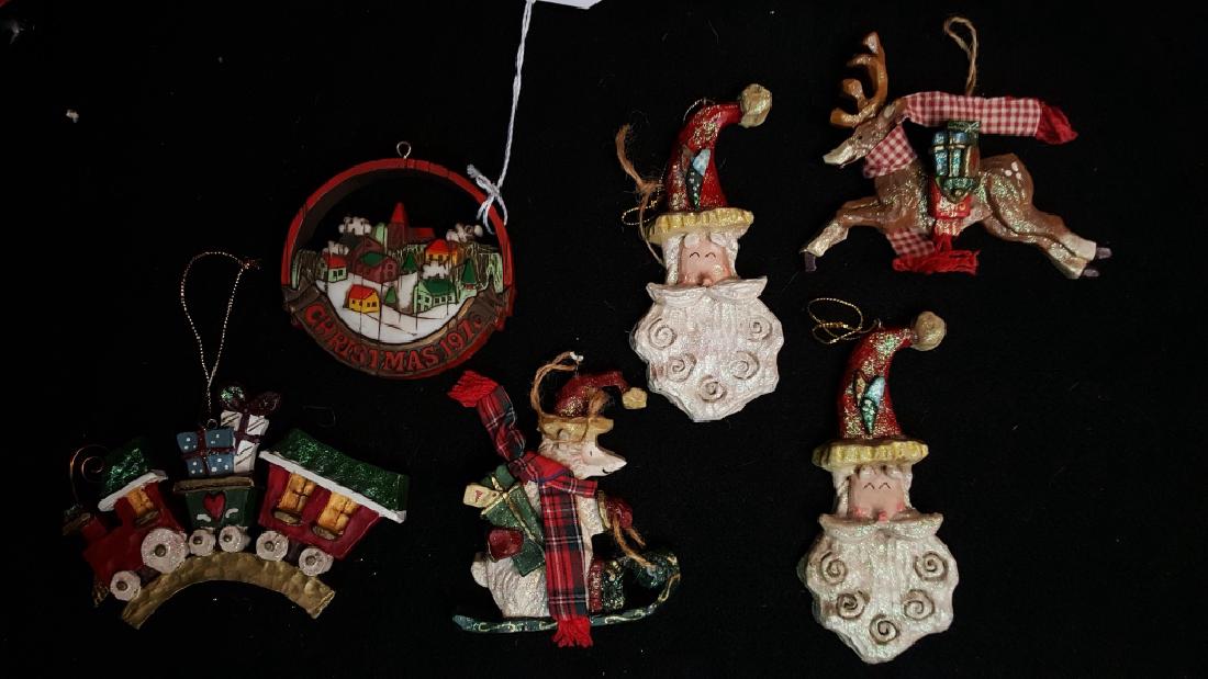 Kurt Adler Hand-Crafted Christmas Ornaments: Santa's World / Kurt Adler hand crafted Christmas ornaments. Two Santa faces, reindeer, skiing bear, toy train and "Peace on Earth" ornaments.