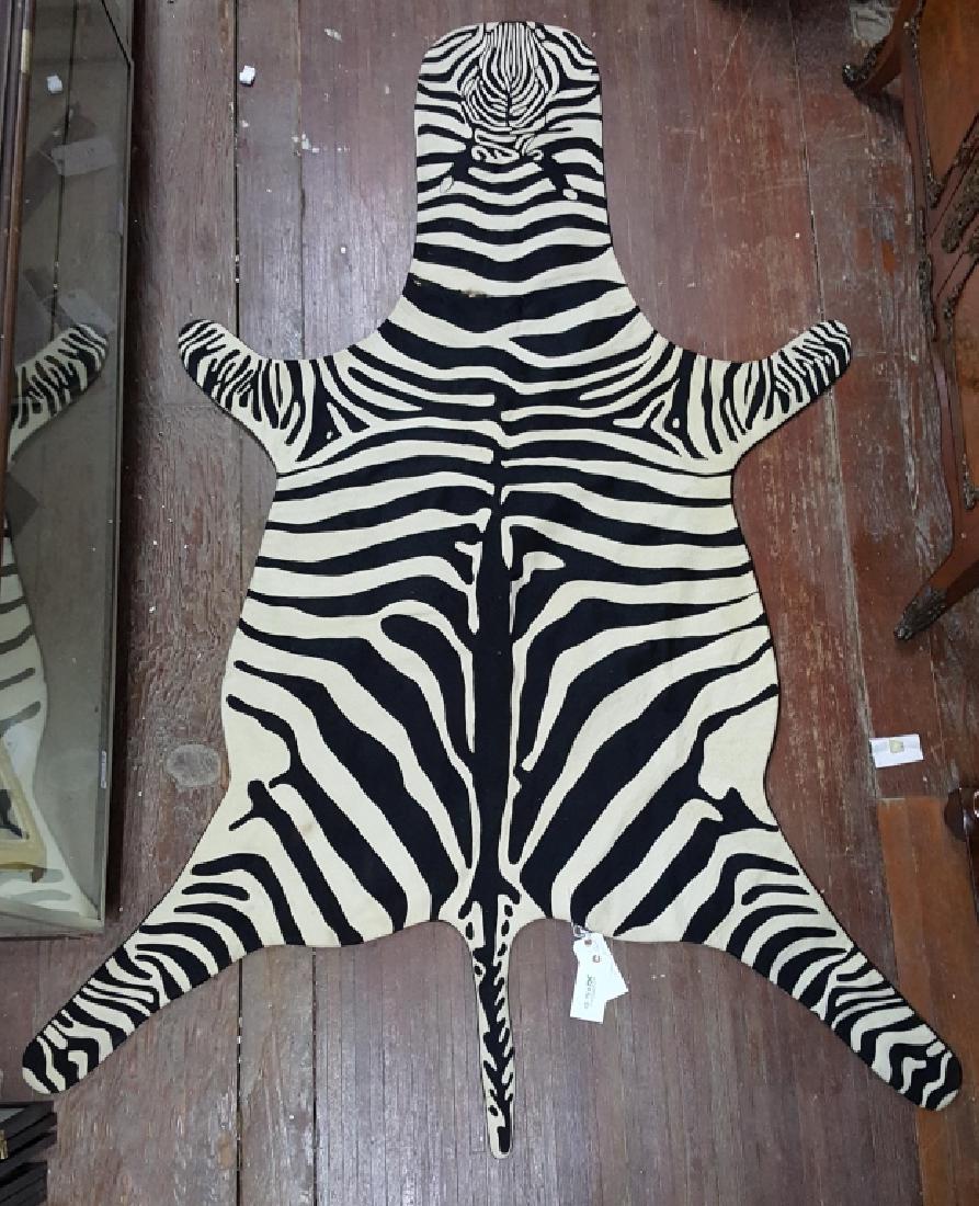 An Armand Diradourian 100% Wool Zebra Rug: Retailed by Saks Fifth Avenue, original retail $895. Appx. size 93" x 54". Some slight loses near "neck" area. Does not appear to have been used on a floor.