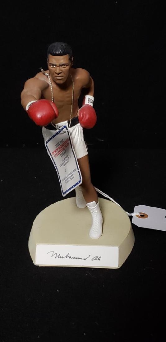 Rare Muhammad Ali Salvino Autographed Figurine: 1990 Salvino Sport Legends LE 1328 of 3500. Hand-painted figurine of Muhammad Ali, showing the legendary boxer while throwing a right cross. Signed by "Muhammad Ali" in black ink on a nameplate affixe