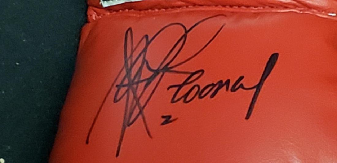 Gerry Cooney "The Great White Hope" Signed Glove: An official Everlast size 12, Gerry Cooney autographed boxing glove. Signed by "The Great White Hope" with a black marker.