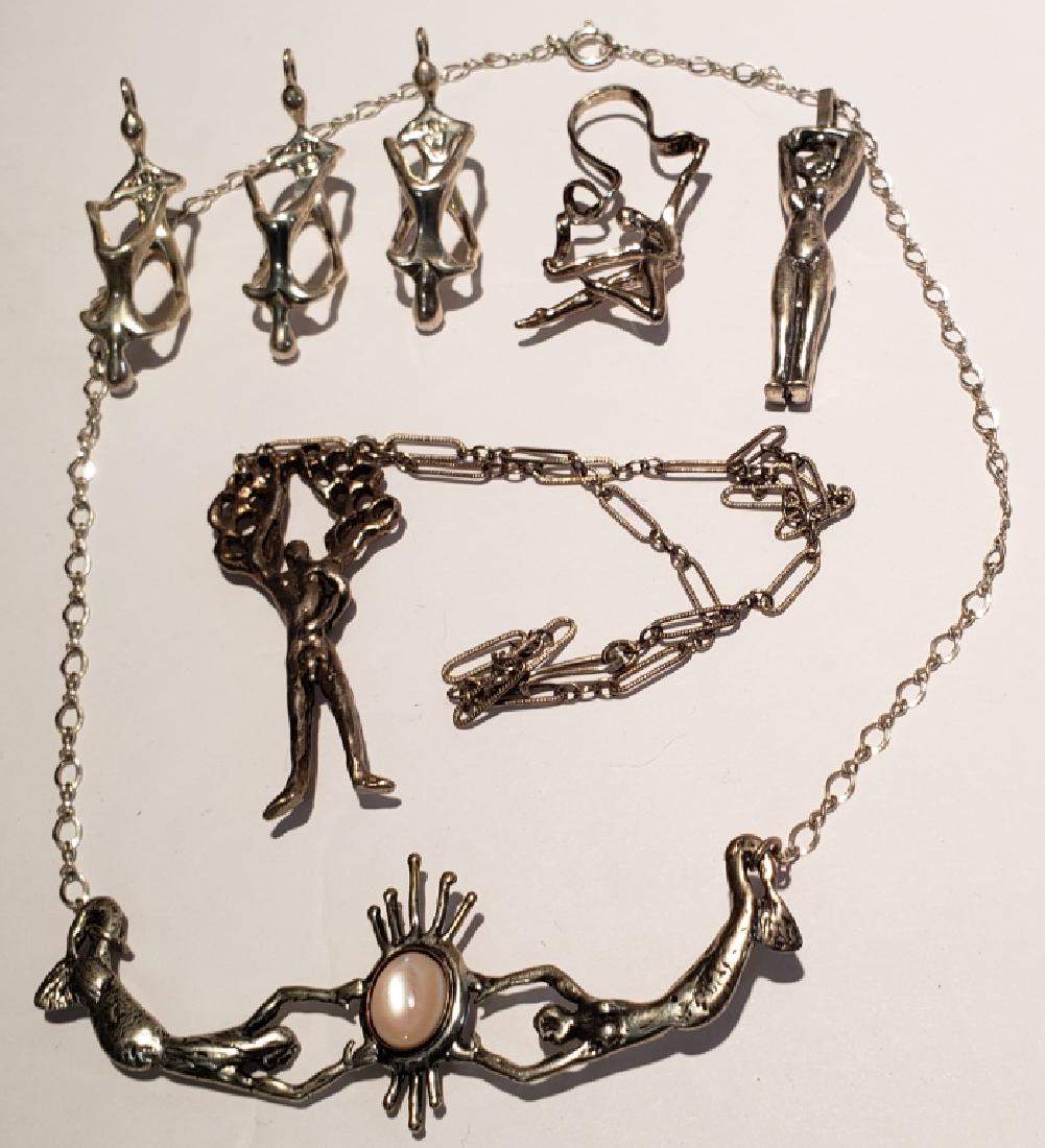 Modern Sterling Silver Figural Pendant Group (7): Includes 3 pendants with two figures marked MCA and .925, 1 7/8", female figure under tree on necklace, female figure marked "ster", ribbon dancer figure, and a necklace with 2 mermaids (roughly 3" wi