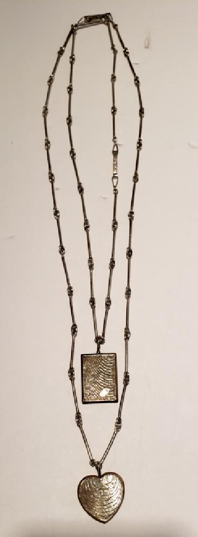 Two "RUBI" Vintage .916 Silver Necklaces: The first, a "Taurus" pendant, signed "RUBI", 1.25" x 1", the clasp signed "Rubi" and ".916", the second a "heart" pendant, signed "RUBI", appx. 1.5" including hok, clasp marked "Rubi" and "916".