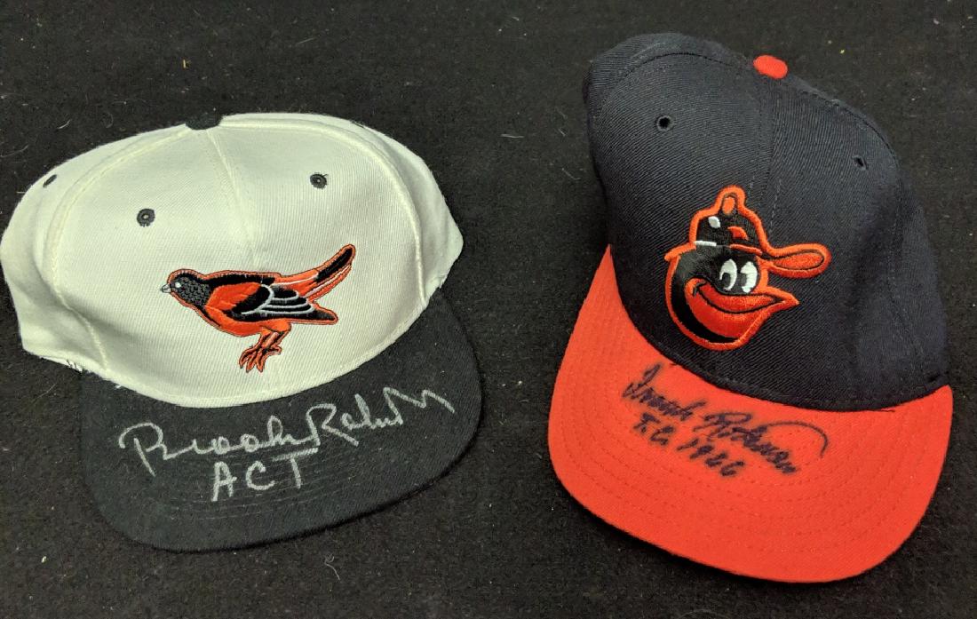 Orioles Brooks & Frank Robinson Signed MLB Hats: MLB Baltimore Orioles Frank Robinson signed hat with inscription "T.C. 1966". Along with Brooks Robinson autographed hat, inscription "ACT".
