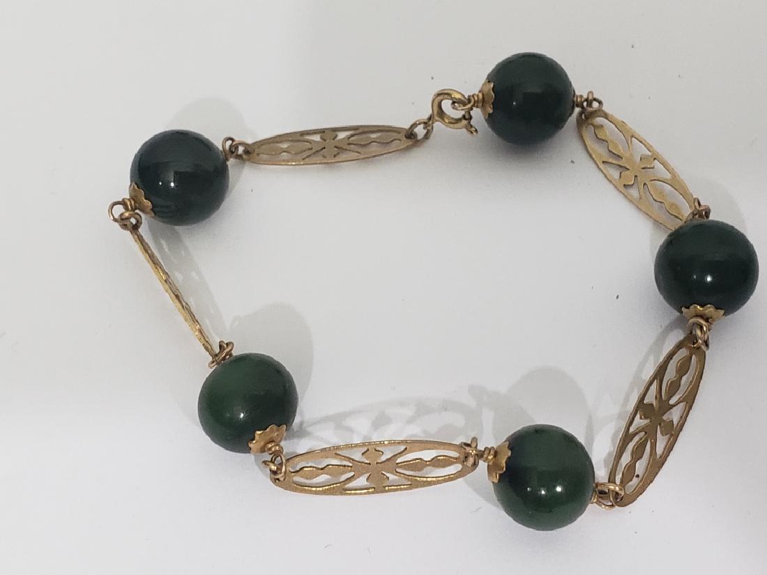 Vintage 14K Gold & Jade Bracelet: 7.5" overall length, each ball roughly .25". 5 jade bals. Clasp marked "14K".