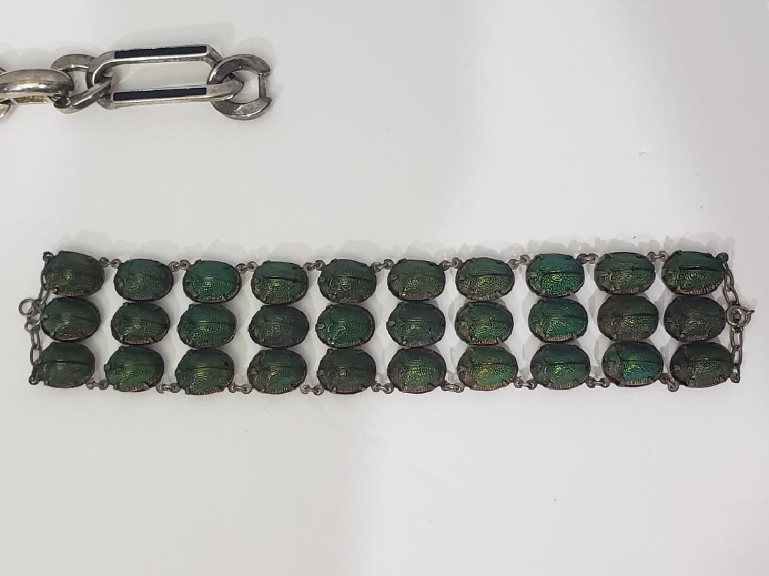 Antique Bracelet With Real Scarab Beetles: Rare Victorian Scarab bracelet with actual scarabs. Triple row of beetles, 10 rows long. 1.5" wide x 6" overall length. Beetles in good condition. On unmarked silver backing.