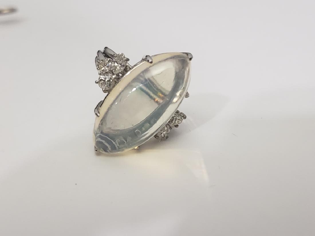 14K White Gold, Diamond & Opal (?) Ring: Large ring in 14K White Gold. With 6 small but not tiny diamonds. The center stone appears to be an opal but the matrix of the stone is very clear. Unusual ring. 5.1 DWT.