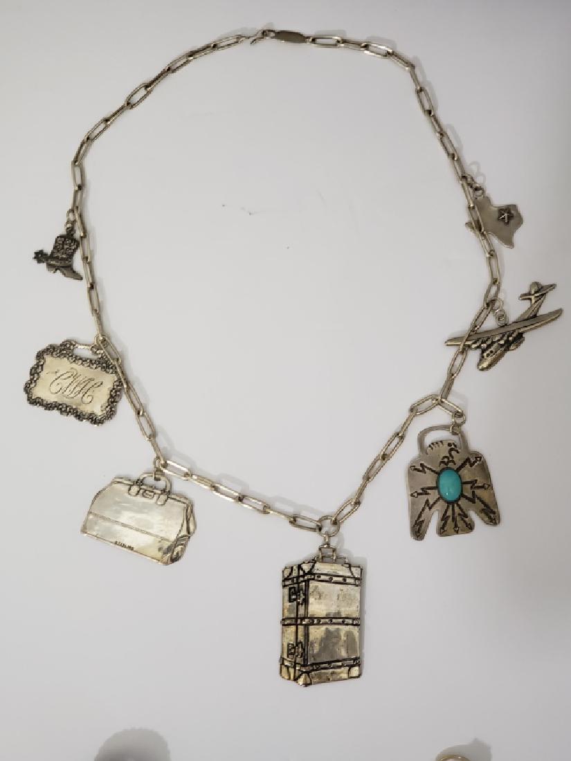 T. Foree Sterling Silver Charm Necklace: Interesting T. Foree Sterling silver necklace with 7 charms. Travel or Texas theme. Western boot with spur, initialed charm, Gladstone bag, trunk, Thunderbird with turquoise, Jet plane, Texas charm wi