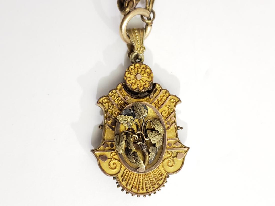 Victorian Gold Filled Locket With Relief Flowers: Locket 1.75" tall to top of flower, 2.25" to top of bail. On roughly 18" chain. Chain has alternating "fan" and "diamond" designs. Locket is empty but does have glass. Front of locket has relief flowe