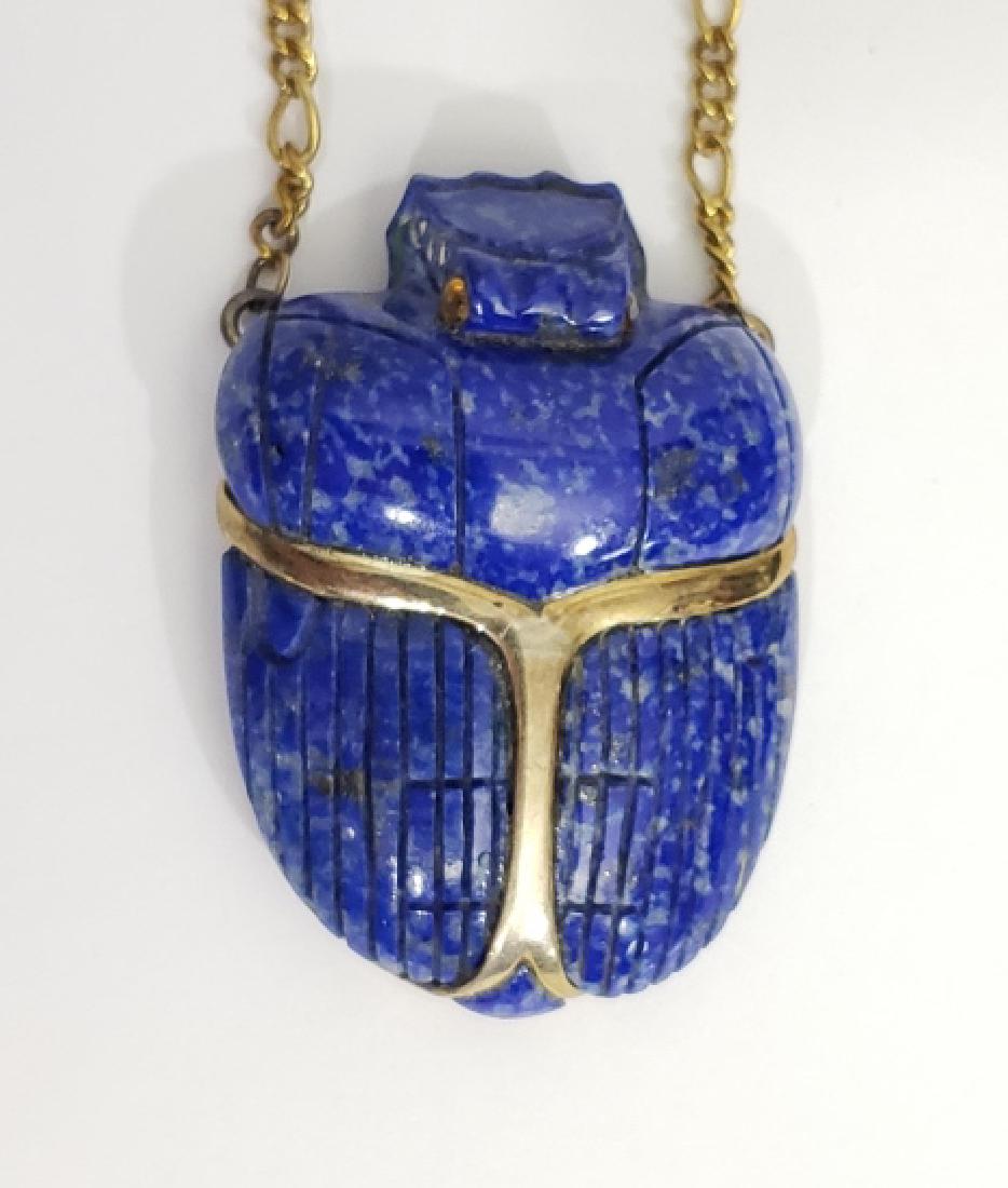 A Large Lapis Carving of a Beetle / Scarab: The carving just over 2" tall, 1 3/8" width. On a silver 16" chain, marked "silver" on reverse of clasp.