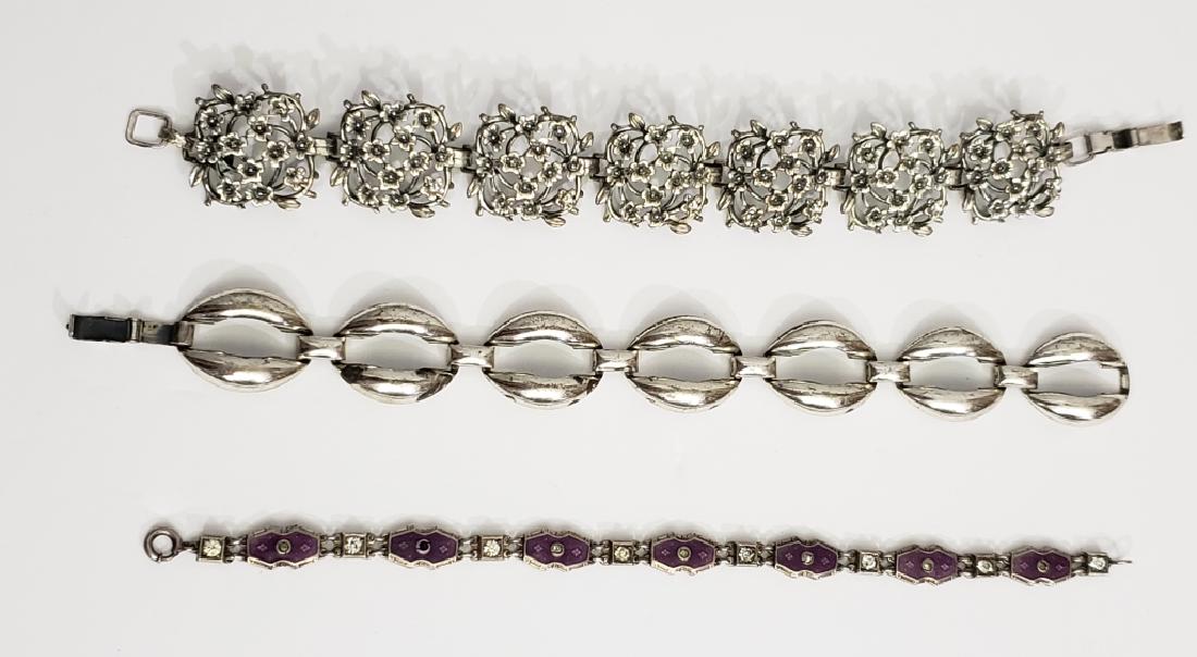 Group of 3 Sterling Silver / Silver Bracelets: Alice Caviness sterling silver floral bracelet, 7.5", 2) Danecraft sterling silver oval links, 7", 3) Sterling, pink enamel and rhinestone, 7", some stones missing, marked "Sterling" and a tiny, unkno