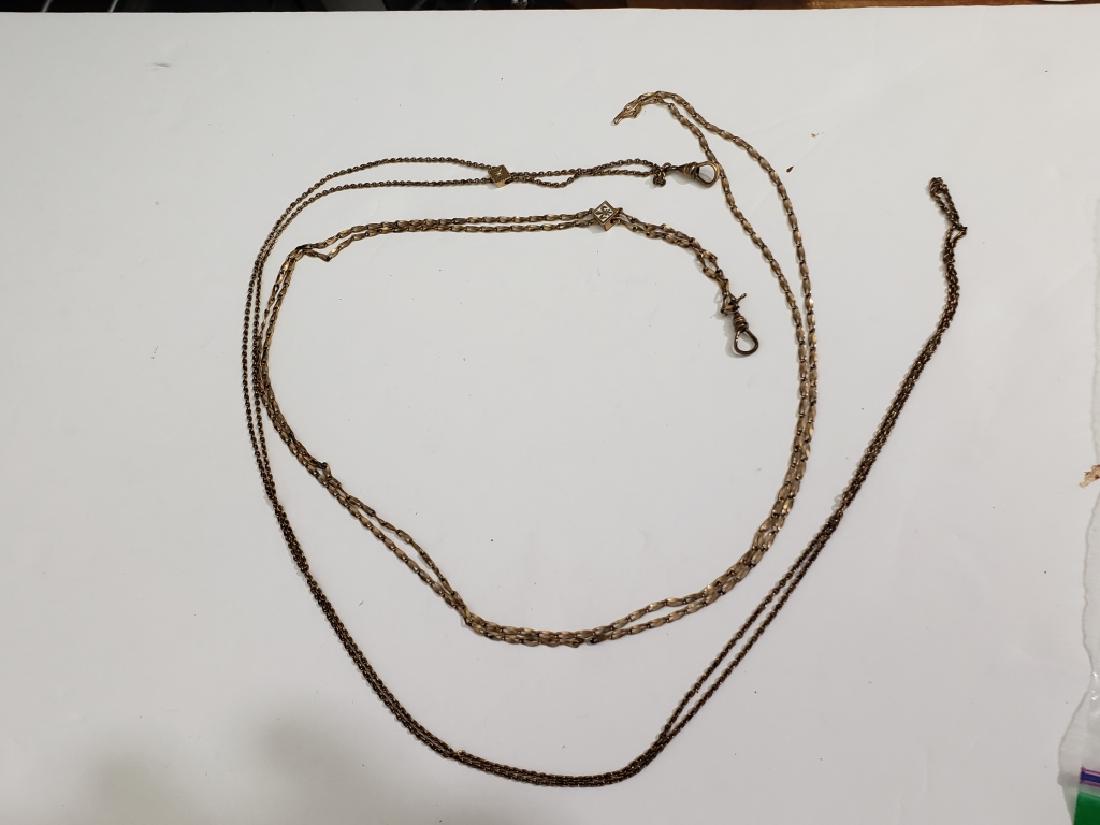 2 Victorian Opera Length Chains With Slides: 1) A Small slide with a Fleur De Lys in white enamel, .25" square, chain appx 49" overall, 2) Small opera slide on long chain, chain 48" appx., small pearl on opera slide.slide appx. 3/8".