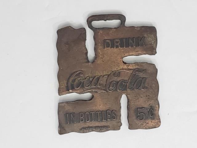 Early Coca-Cola Swastika Watch Fob: C. 1920's hammered copper watch fob. 1 9/16" x 1 5/16". "Drink / Coca-cola/ in bottles 5c", "Schwaab Milwaukee".