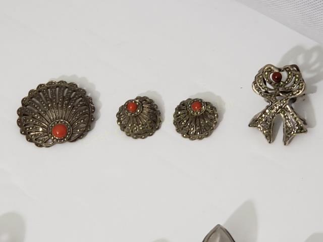 Sterling Marcasite & Red Stone Group (3): 1) "Fan" pin, 1.5", ".925", together with 2) Matching earrings, 7/8", Clip on, 3) Large bow shaped ring, 1.5", red stone at top, "Sterling". Total weight appx. 1.47 Oz. Troy.