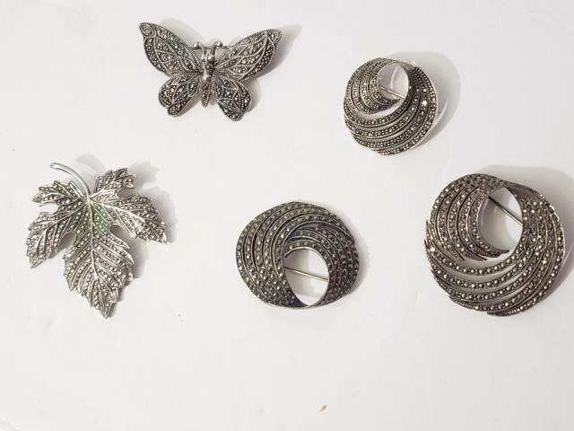 Group of 5 Marcasite & Sterling Pins: 1) Leaf, 2 1/8", "Sterling", 2) Butterfly, 2", ".925", 3) Swirl pin, 1.75", 4) Swirl pin, 1.5", ".925", 5) Swirl pin, 1.25", ".925". Appx. Weight 2.2 Oz. Troy.