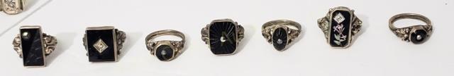 7 Sterling Rings With Onyx Centers: 1) Rectangle, 5/8", marcasite center, 2) RTectangle, 5/8", Diamond chip at center (?), 3) Rectangle, carved surface, small marcasite at corner, 4) Rectangle with flower and small diamond (?) chip, 5) 