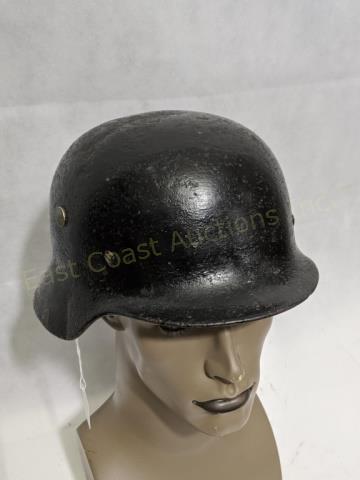 WWII German Military Helmet: A black WWII German Helmet with leather head liner. 9 1/4" X 11 1/2" X 6 1/2"