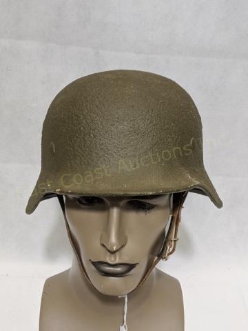WWII German Military Helmet: A dark green WWII German metal helmet with head liner and chin strap. 9 1/4" X 11 3/8" X 7"