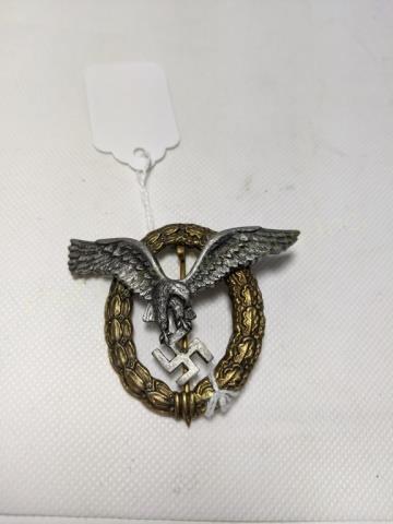 WWII German Luftwaffe Pilot Badge: A German Luftwaffe Pilot badge. The rivets holding the eagle are slightly loose. 2 1/2" X 2 1/8"