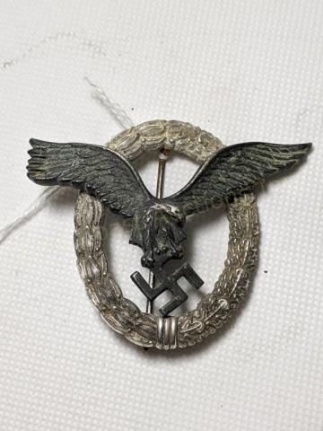 WWII German Third Reich Luftwaffe Pilot Badge: Luftwaffe flying eagle clutching a swastika, surrounded by oak leaf wreath. Stamped " L / 58 " ON BACK. 2 1/8" X 2 9/16"