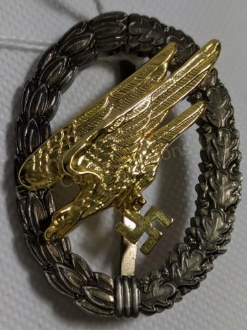 WWII German Luftwaffe Paratrooper Badge: WWII by the manufacturer C.E. Juncker in Berlin. The wreath in nickel-silver, silver-plated and toned, the riveted eagle embossed in bronze and gilded. 2 1/4" X 1 5/8"