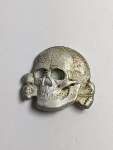 German WWII SS Peaked Hat Totenkopf Skull: Third Reich SS peaked hat Totenkopf insignia. Age toned silver skull. Reverse marked "SS" RZM and "155/38".