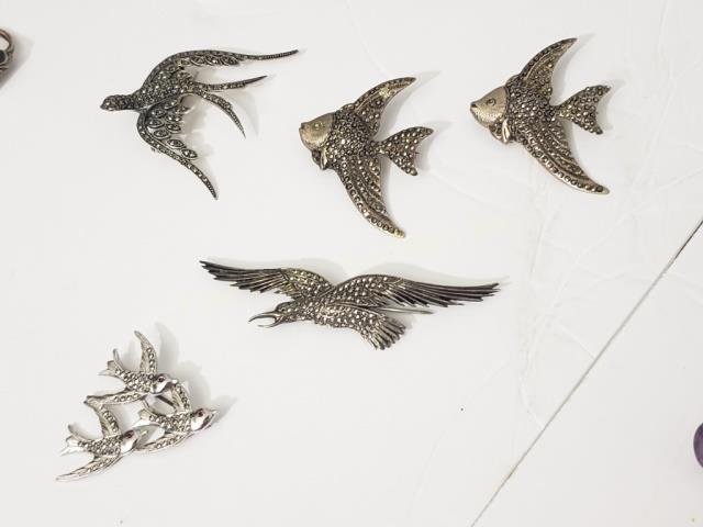5 Sterling & Marcasite Pins Animal Form: 1) Fish, 1 7/8", 2) Fish, 1 7/8", 3) Large Bird, 3.25", 4) Large bird, 2", 5) 3 small birds, 1 5/8". Total weight 1.64 Oz. Troy.