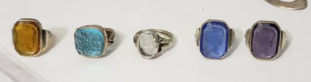 Group of 5 Sterling Silver Cameo Intaglio Rings: 1) Clear, woman looking right, .5", "Sterling", 2) Yellow, Neoclassical woman looking right, .75", "Sterling", 3) Purple, neoclassical woman looking right, "Sterling", 4) Blue, Woman looking right, "S