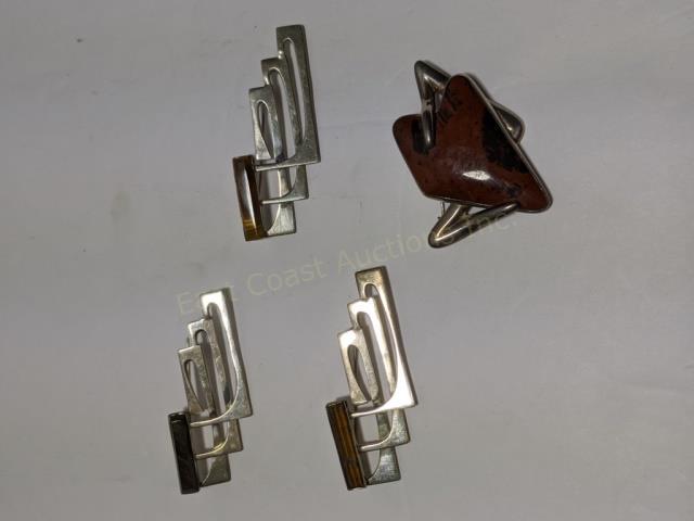 4 Mexican Silver Designer Sterling Pins Sigi: 1) "Sigi" with polished jasper (red & black), 2", 2) "Sigi" with small tiger's eye, 2.5", 3) (same as 2, tiger's eye), 4) (same again, onyx). Total weight of group is appx. 1.9 Oz. Troy.