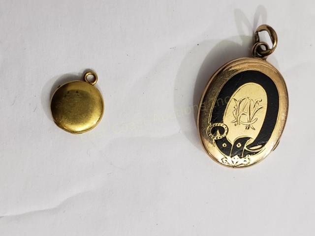 Two Small Gold (?) Lockets, One Very Tiny.: 1) Tiny plain locket, 3/8", unmarked, no interior, 2) English (?) antique locket with black enamel, small flaw to enamel at lower right, with "CAW" (?) initials on front, possibly a mourning locket (?
