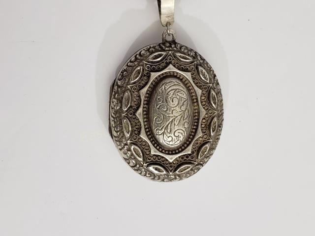 Large Antique Victorian Silver (?) Locket & Chain: Chain 17" appx. total length. Chain apparently unmarked. Locket appx. 2" tall, with ornate front. The suspension bail appears to be replaced and is not great quality/ make do repair. Locket is empty n