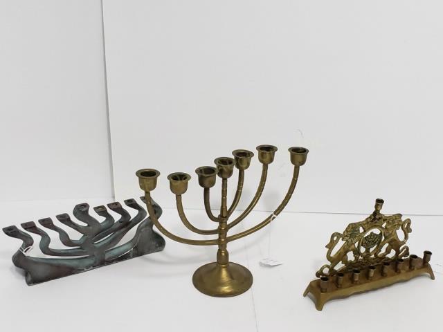 A Group of 3 Menorahs: 1) Brass, 8.75" wide, with lions on back plate, 8 candles at base, one candle at top. 2) Patinated metal modern menorah, 10.25" wide, 4.5" tall, apparently unsigned, 3) 7 light brass menorah, 8.5" tal