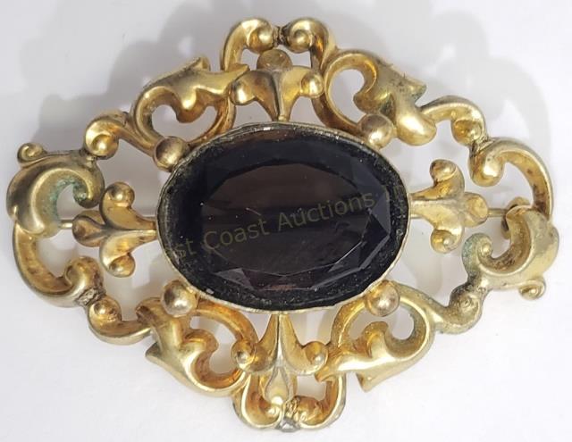 Large Victorian Antique Gold Filled Brooch: Large antique Victorian gold filled brooch with large central stone. Central stone is a smoky quartz (?). It is faceted and 12" largest dimension. Brooch overall is 2.5" x 1 7/8".
