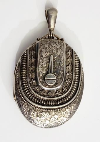 Large Sterling Silver Victorian Locket Engraved: The locket is appx. 2 1/8" tall. With elaborately engraved front. Interior is empty- no glass, no photos. Marked on reverse "CS", "FS", "(lion)", "(anchor)" and maybe a date letter of "E" (date letter