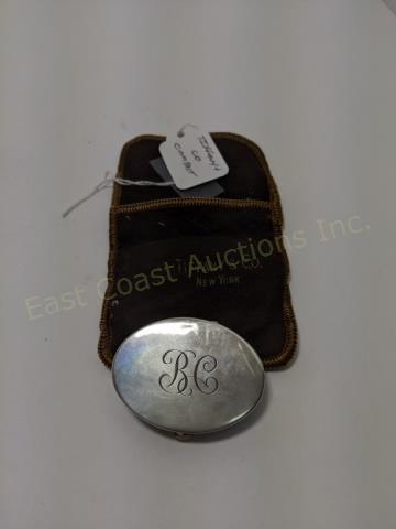 Small Tiffany & Co. Sterling Silver Compact: Top initialed "B C". Marked "Tiffany & Co.". No silver mark, but undoubtedly silver. With mirrored interior lid. With vintage brown and yellow Tiffany bag.