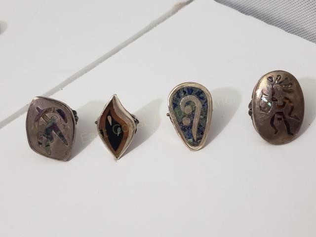 **Group of 4 Mexican Silver Rings: 1) Mixed metals, 1.25", "Sterling", 2) Crushed blue stone, 1.25", "Sterling", 3) Abalone inlay, 1.25", "Sterling", 4) Abalone inlay, warrior, 1 5/16", "Sterling". Total weight of group is appx. 1.24 O
