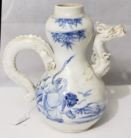 An Antique Chinese Blue & White Teapot With Dragon: The spout and handle of the teapot in the form of a dragon. The dragon missing a few claws front and rear but largely intact. No lid. No marks. 7.75" tall. 7.5" from front of spout to back of handle. 
