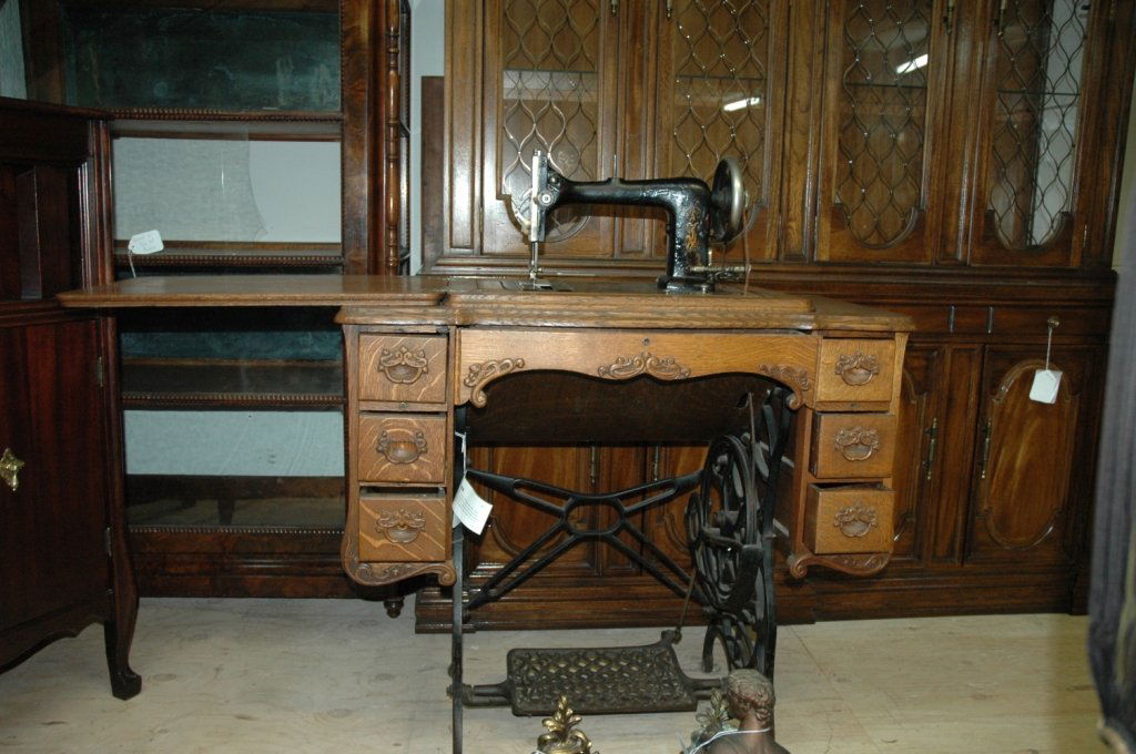 Minnesota "Model A" pop up sewing machine table: Has a chain attached to the machine so when you open the top the Sewing machine pops right up. Mechanics are in great condition. Leather band needs to be replaced. Aprox. Meas. 34"x18"x32