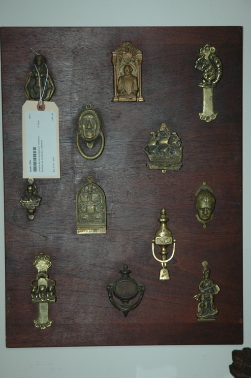 Antique Bronze doorknocker collection: 12 Door knockers on a board as a collection.