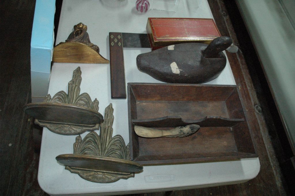 Wood lot.: Vintage Duck decoy. Carved shoe horn. With rabbit head. Cutlery tray. Brass inlayed Antique Square. painted red and gold box. Three carved wall shelves.