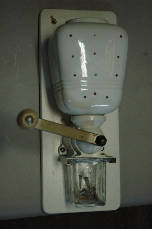 Porcelain coffee/spice grinder: Has crackle finish glass measuring cup on bottom missing lid Mounted on a 12x5 piece of wood
