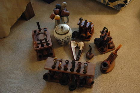 41 piece pipe collection: An assortment of antique to more modern tobacco pipes. some with stands and a Delft porcelain tobacco urn.