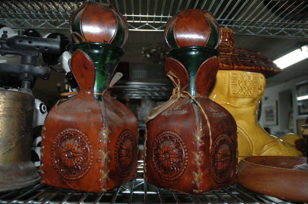 Vintage Italian Leather / Glass Bottle / Decanter: Here are a pair of leather wrapped European glass wine decanter bottles. They make wonderful curios on a shelf or end table as permanent home decor or used in "staging" a home for sale or in window di
