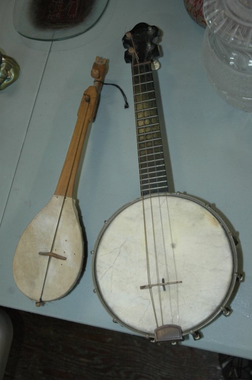 Hammer Banjo + Hand carved Tumbi: Banjo has date 5-10-28 under the skin on the back. 21x7x2.75. The tumbi is a traditional Punjabi string instrument. 16x4x2.5