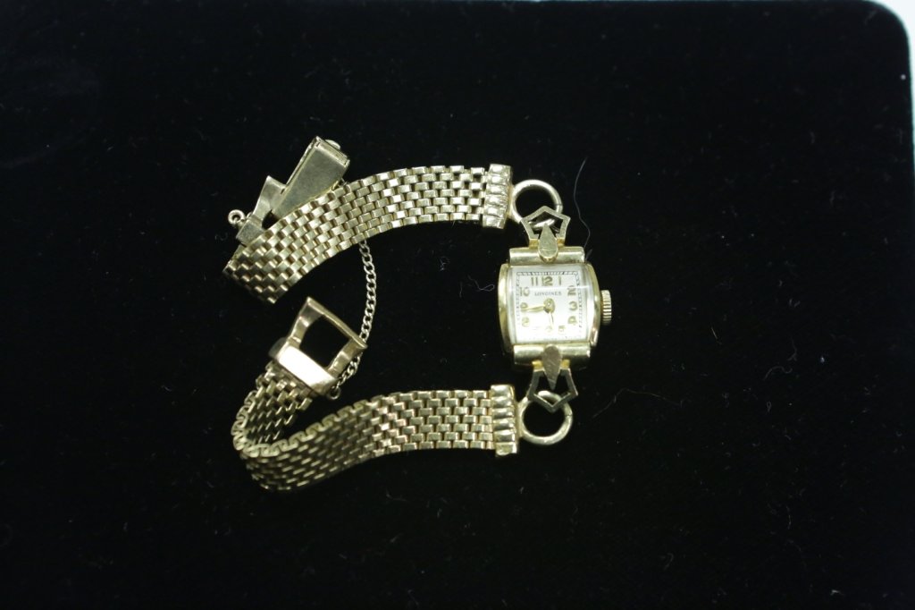 A Ladies 14K Yellow Gold Wristwatch & Band: A Longines ladies wristwatch in 14K yellow gold, with a yellow gold bracelet. Gross weight including crystal and movement, 13.6 Dwt.