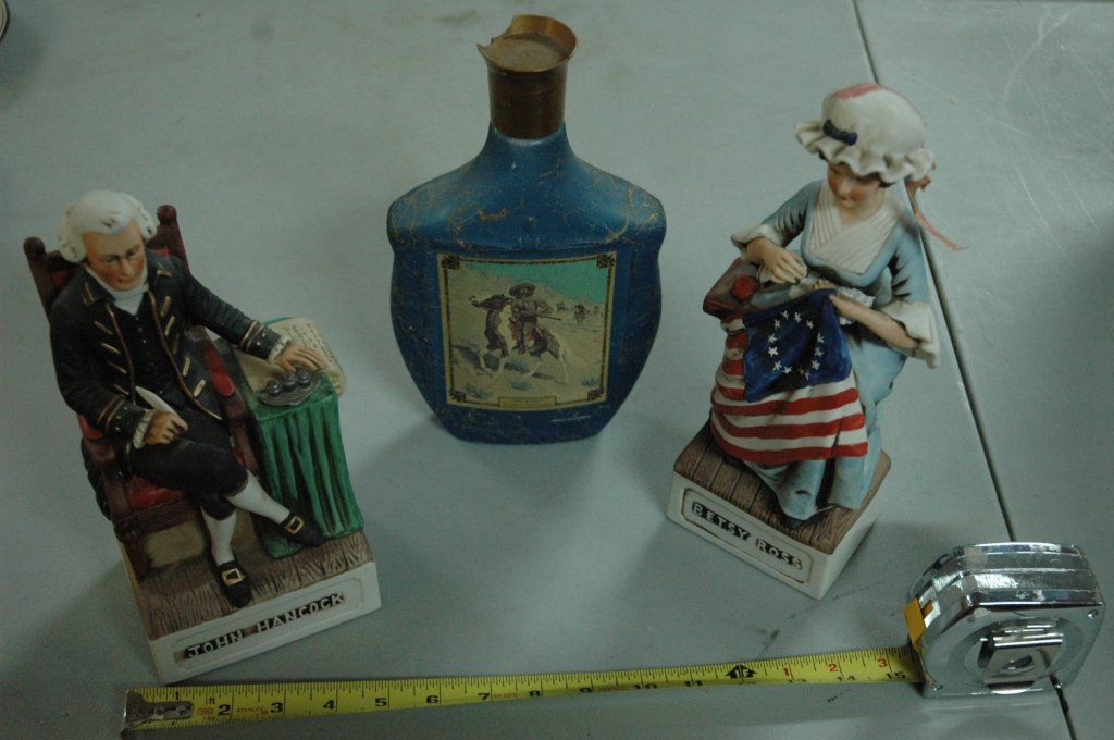 American Porcelian distilling bottles: Betsy Ross 11.25", John Hancock 10", The Scout Frederic Remington 10.25