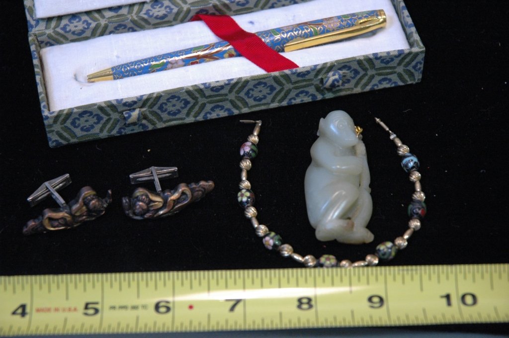 Chinese Jewelry Lot: a cloisonne pen, a carved stone (jade?) monkey, a bracelet with cloisonne beads, and a fine quality pair of mixed metal cufflinks (copper, bronze, and sterling).