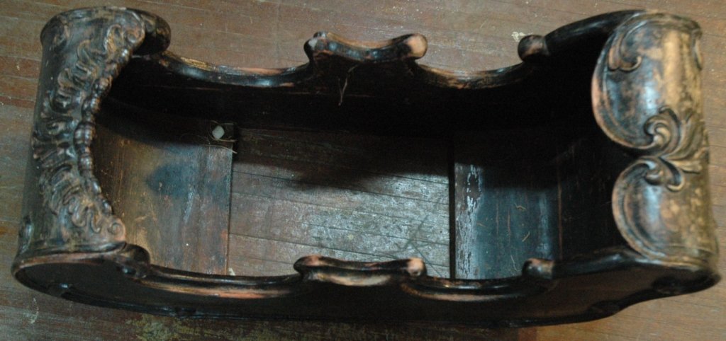 A Pair of Mahogany Sled form Planters: A pair of mahogany sled form planters, the planters on stands. 29" tall x 26" wide x 15" deep.