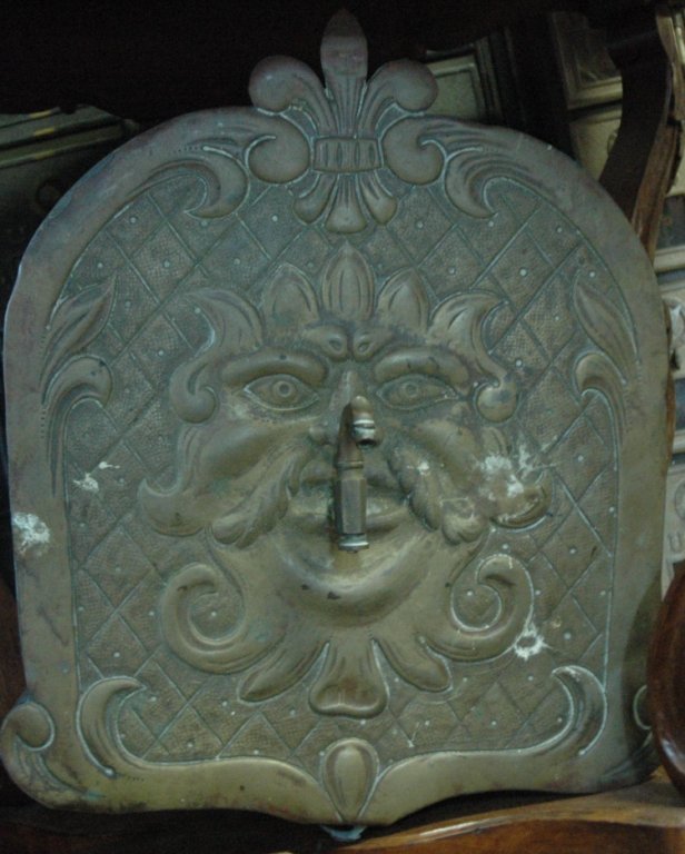 A copper lava bo with devil face: A copper Lava Bo with a North Wind design face. 16" tall x 13" wide x 4" deep.