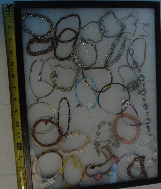 Over 30 assorted bracelets: Stainless, Leather, Beaded, gold and silver tone.